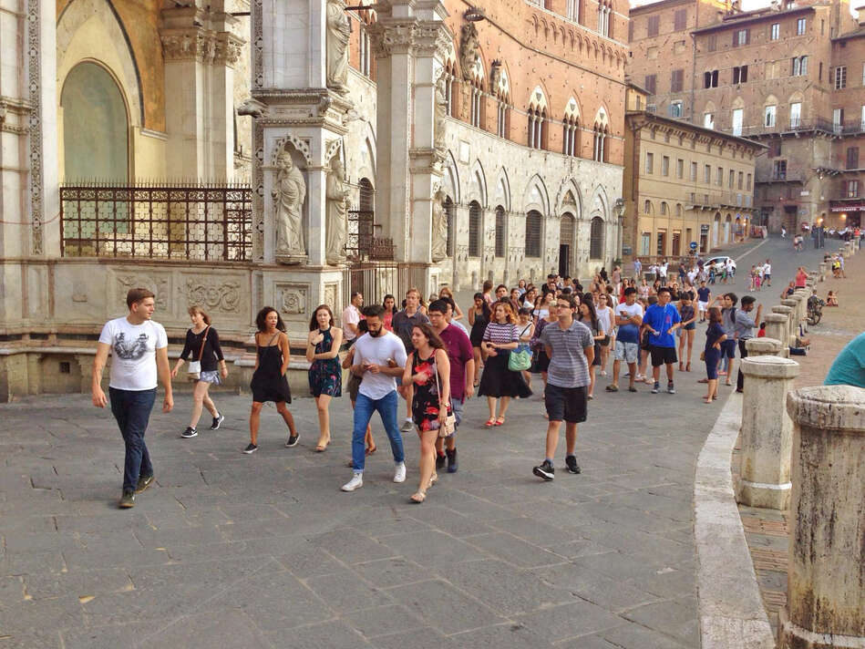 Group of students walking at the Piazza del Campo