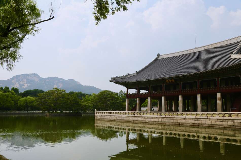Palace surrounded by water with mountain background