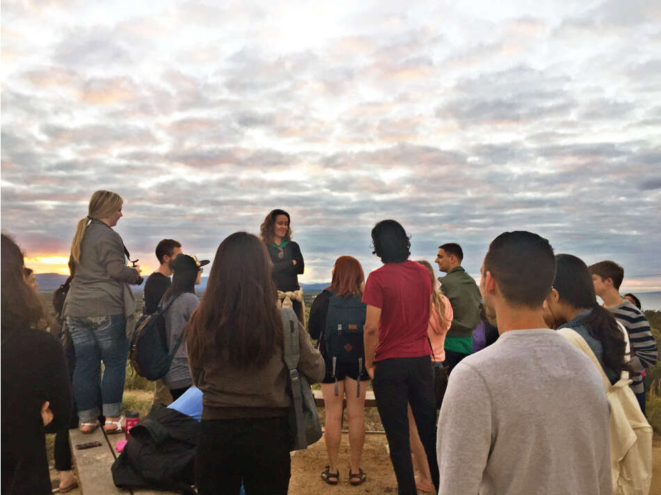 Students at an outdoor lecture on top of a mountain in Byron Bay