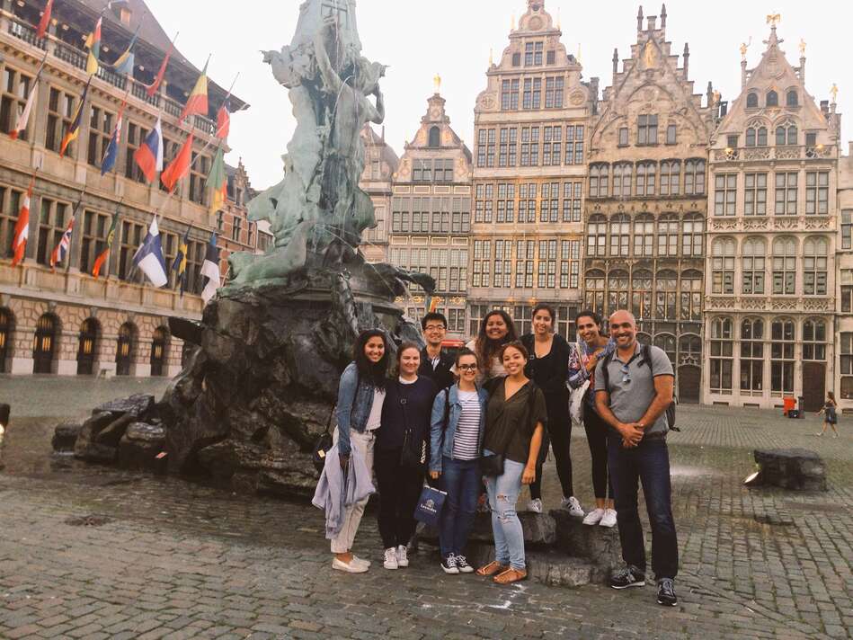 Students and professor by a fountain in Antwerp