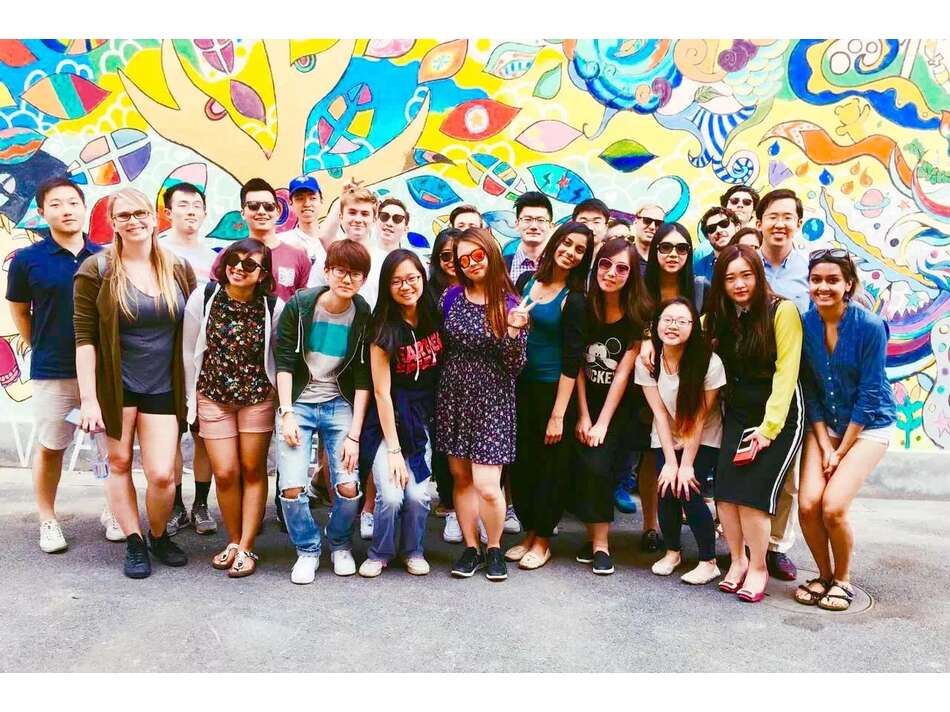 Group of students in front of a graffiti wall