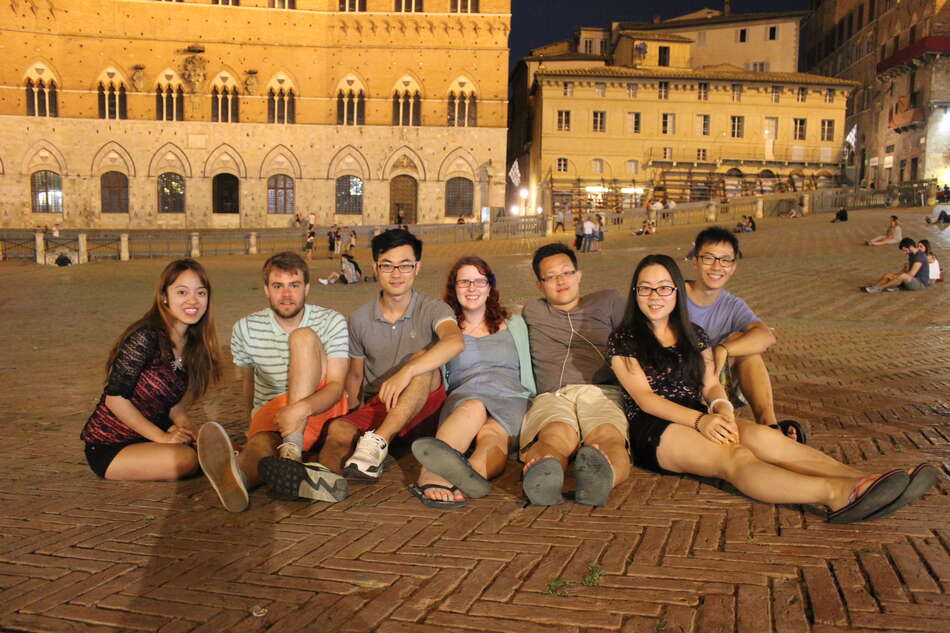 Seven students sitting at Piazza del Campo