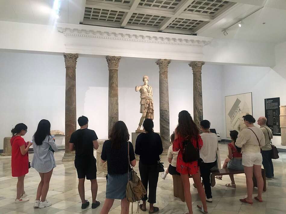 Group of people looking at an exhibit at the Museum