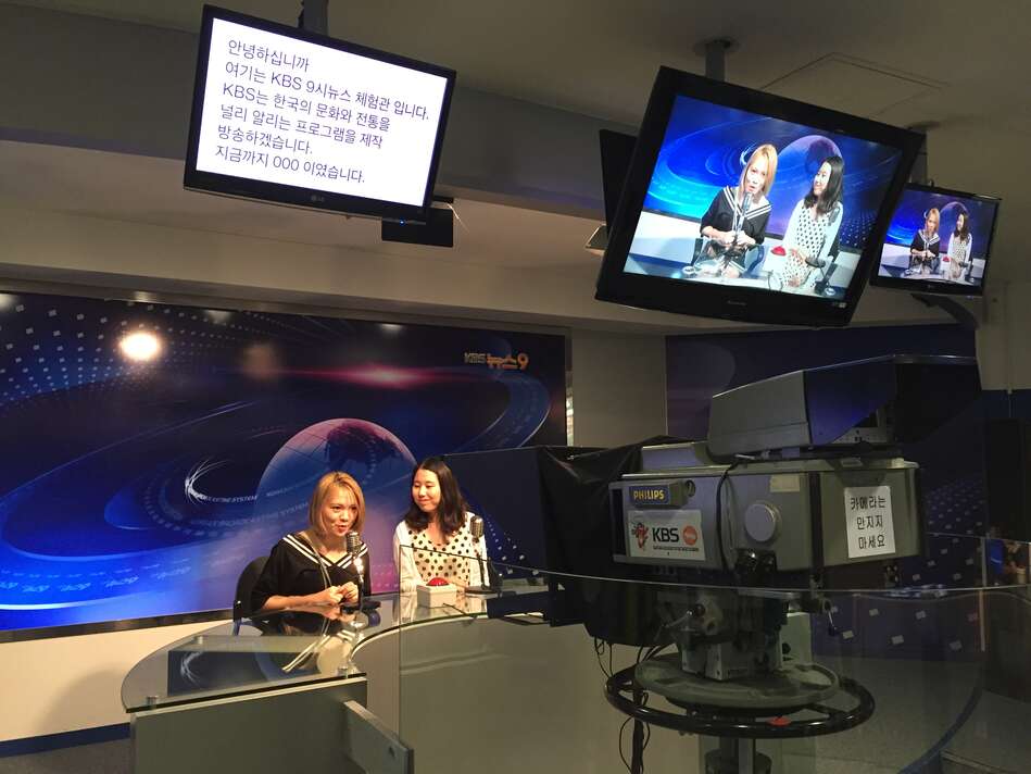 Two students at a television broadcasting studio