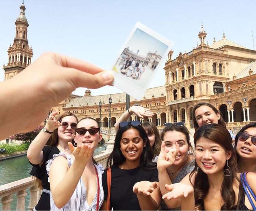 Seven students in front of the Plaza de Espana
