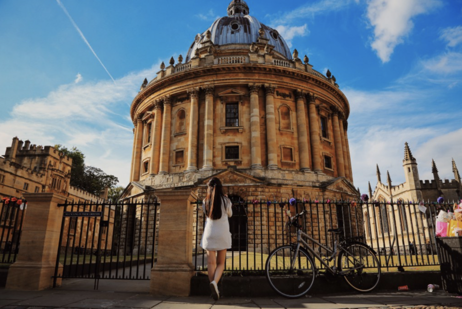 Student facing Radcliffe Camera in Oxford, England.
