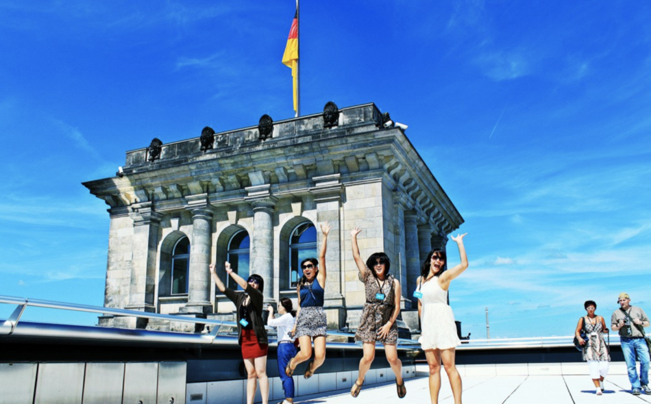 Four students in front of Reichstag, the German Parliament building in Berlin.
